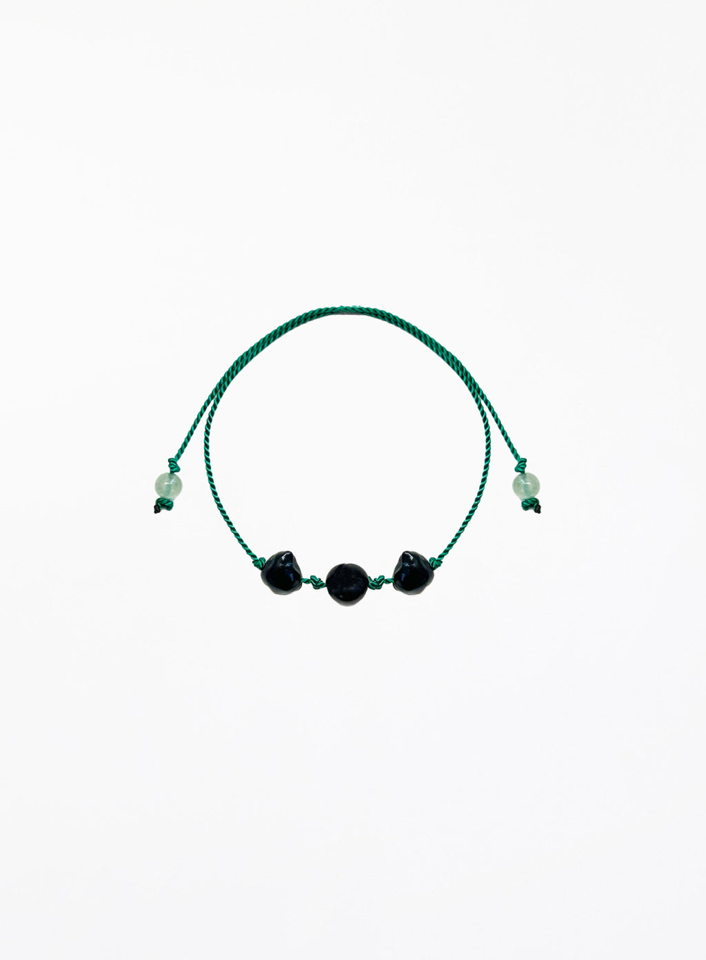 Green bracelet with black pearls on a white background