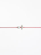 Red string with two pearls on a white background