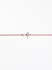 Red string with two pearls on a white background