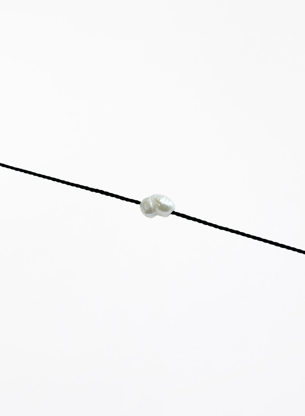 black bracelet with single pearl charm