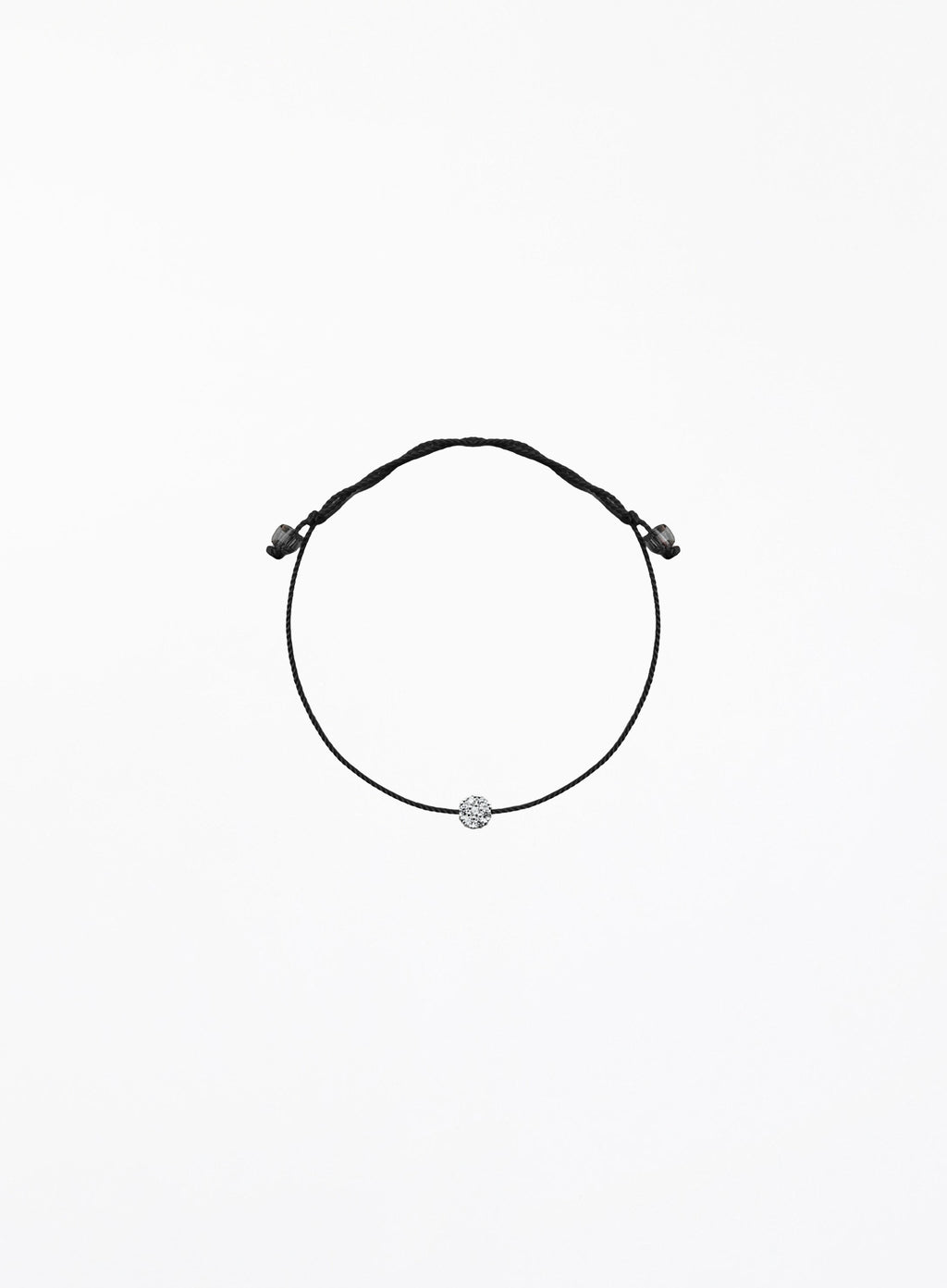 Black bracelet with a small round charm on a white background