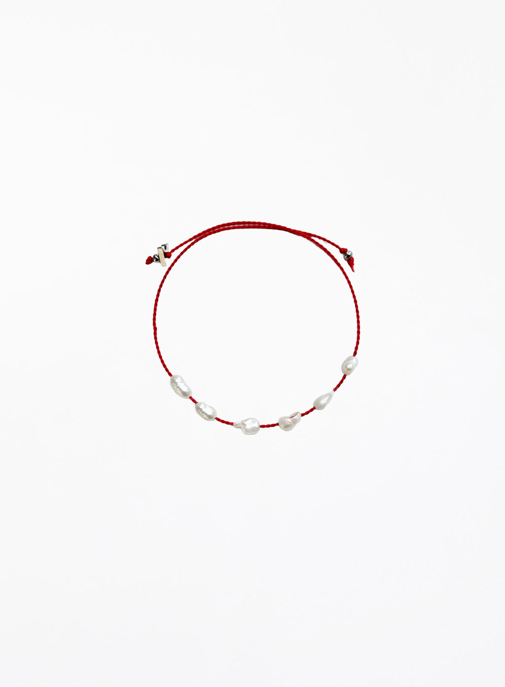 Red bracelet with pearls on a white background