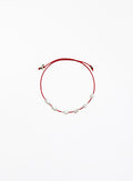 Red bracelet with pearls on a white background