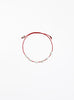 Red bracelet with pearls on a white background