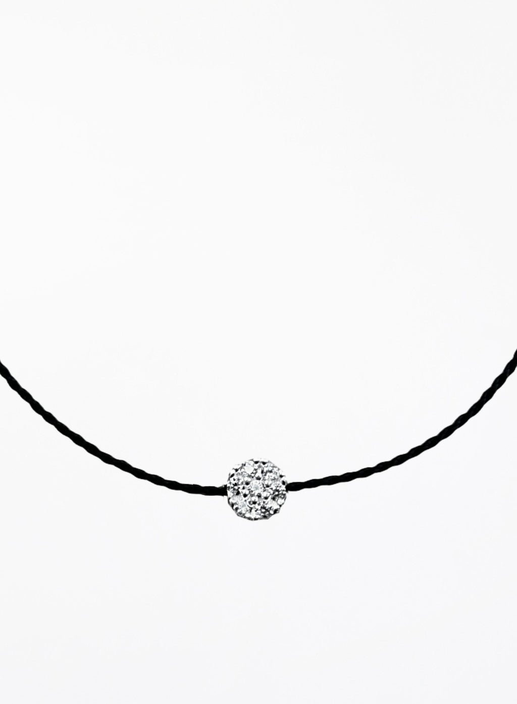 Black bracelet with a round crystal pendant on a white background