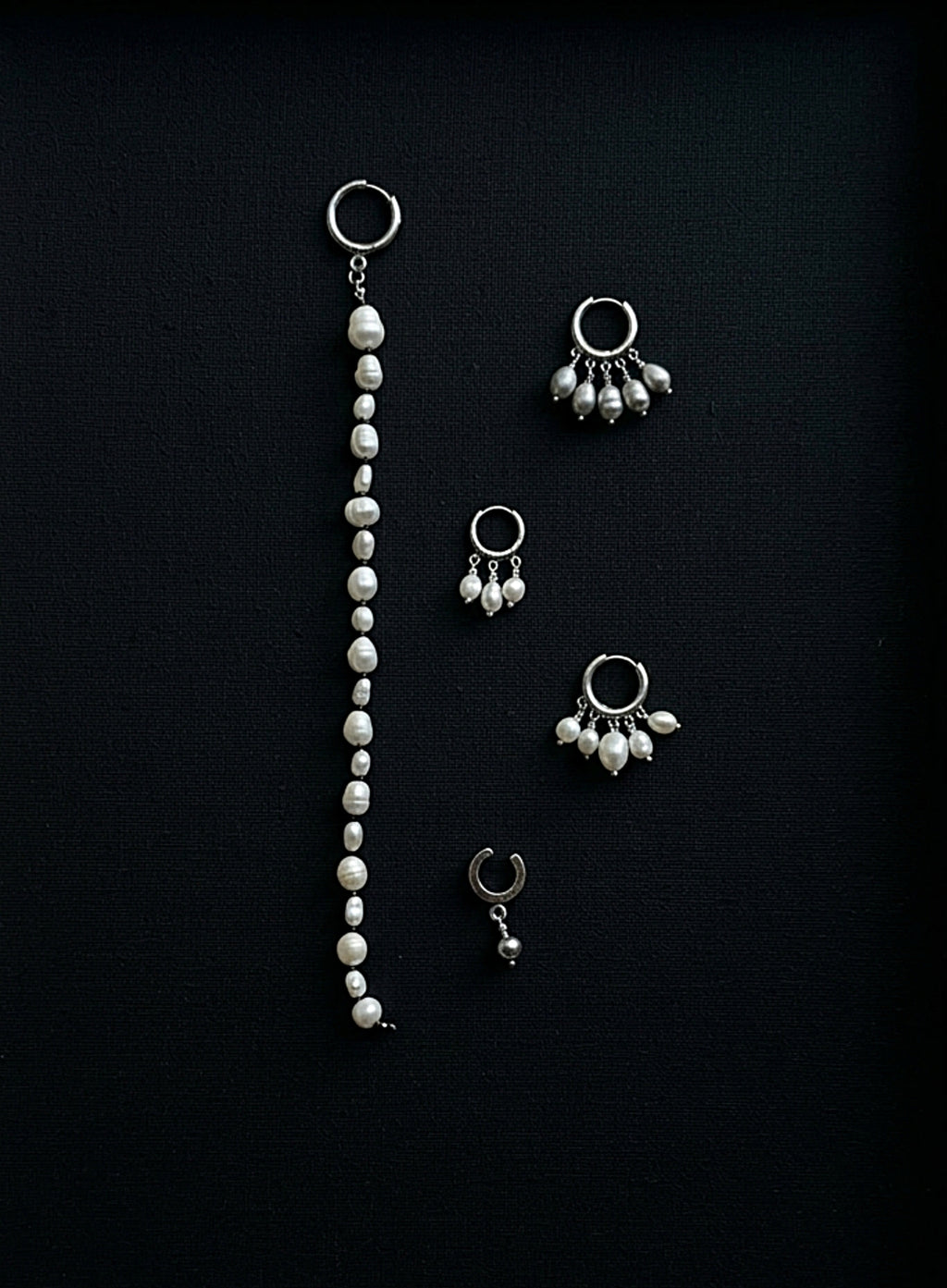 pearl earrings on black background