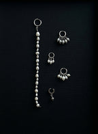 pearl earrings on black background