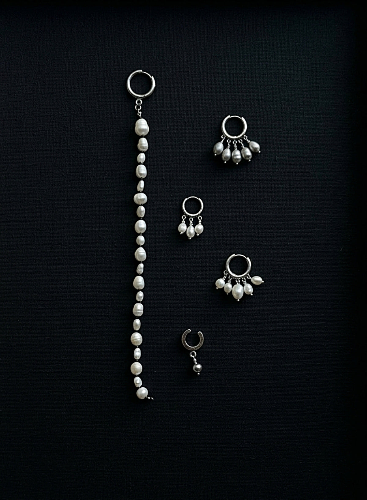 pearl earrings on black background
