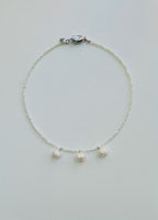 Necklace with three cultured pearl beads on a white background