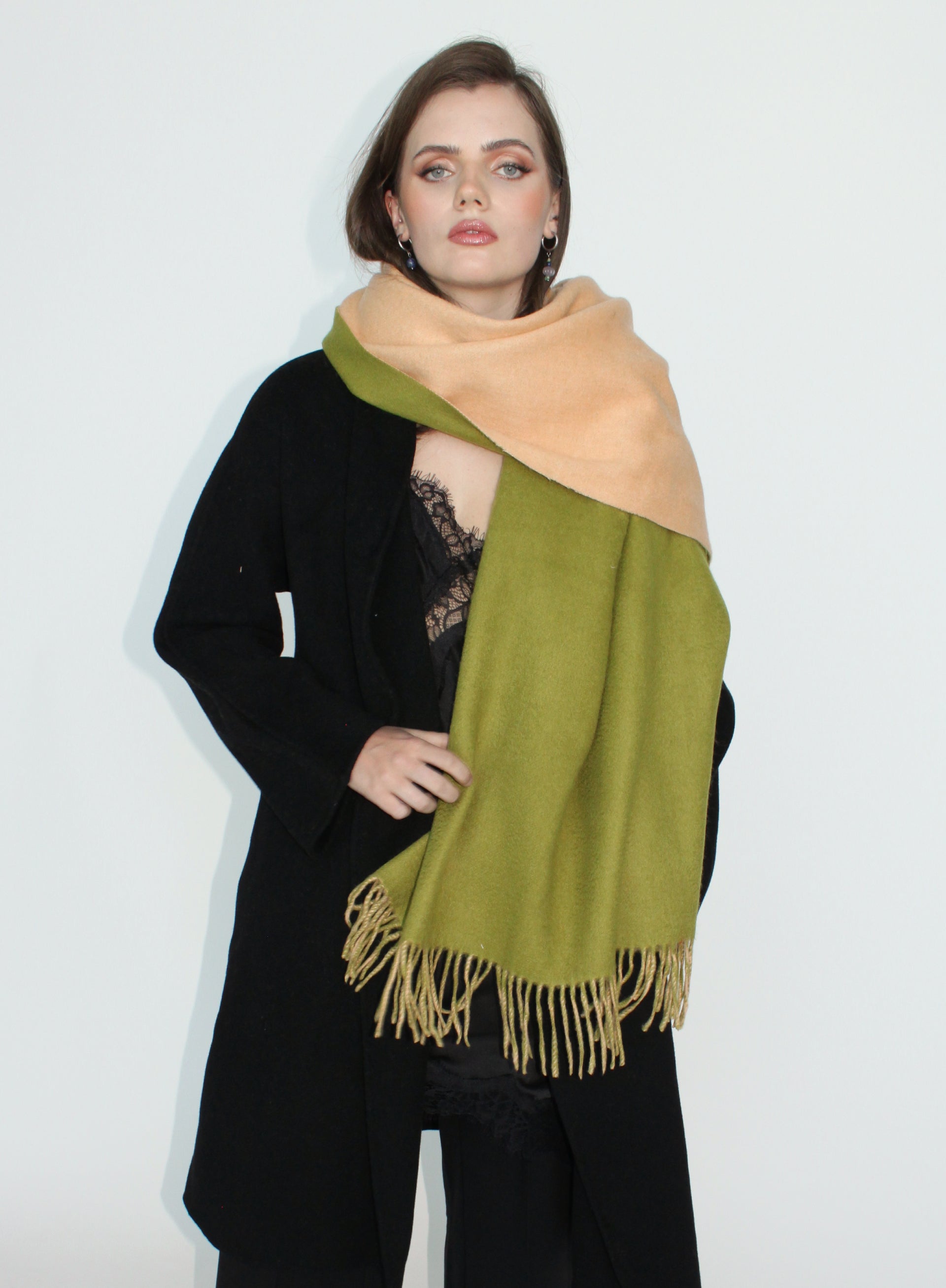 Woman wearing a green and beige scarf on a white background