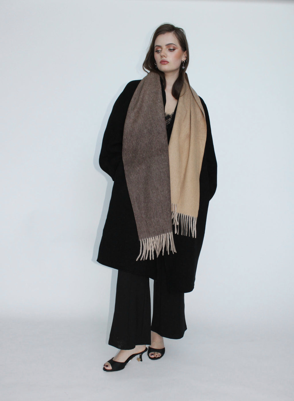 Woman wearing a long scarf with a white background