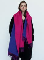 Woman wearing a pink and blue scarf on a white background
