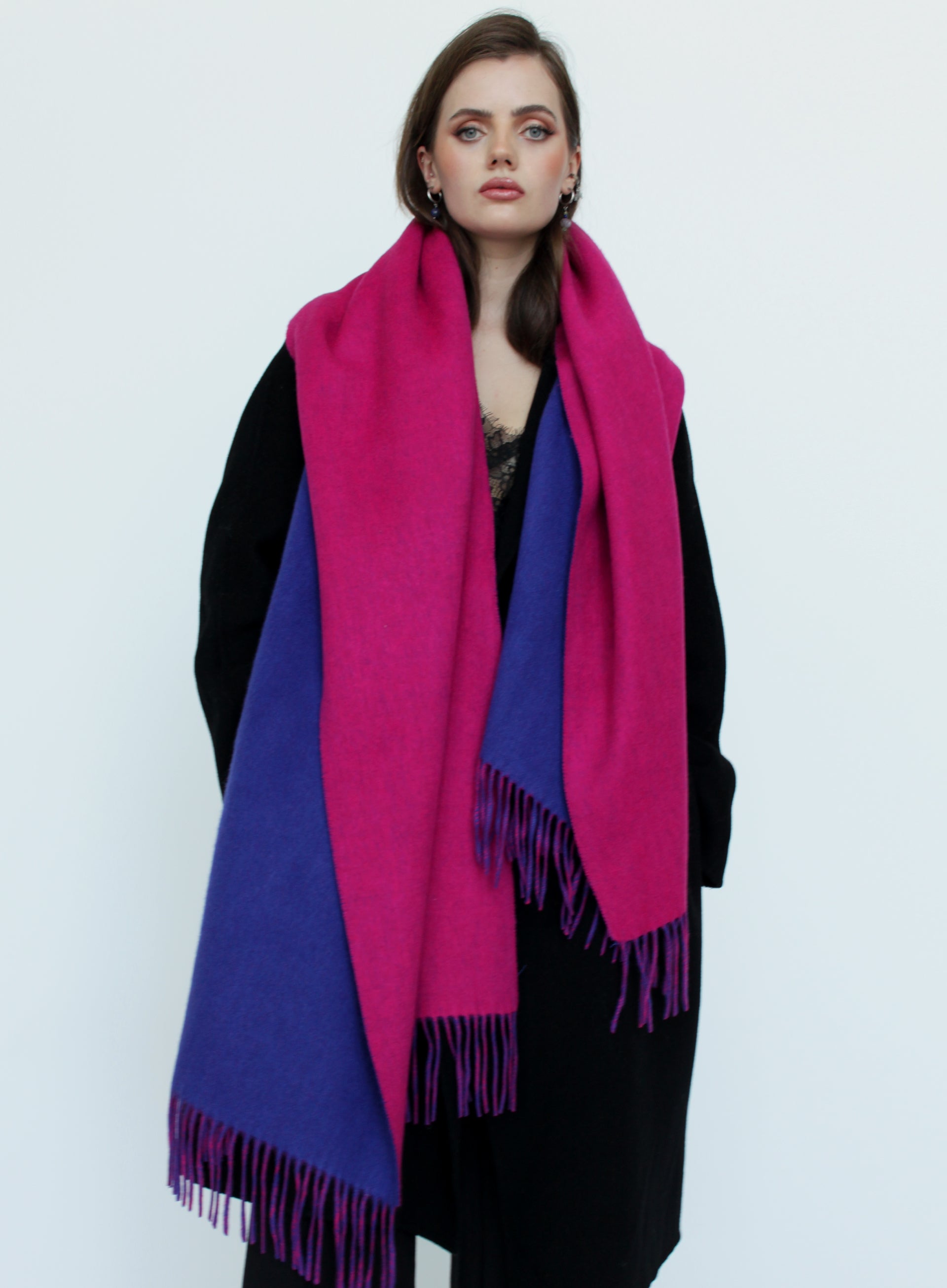 Woman wearing a pink and blue scarf on a white background