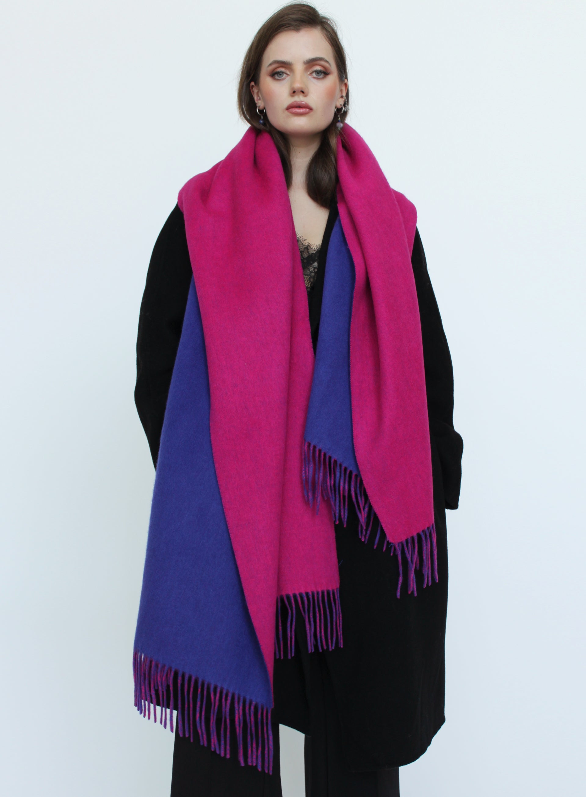 Woman wearing a pink and purple scarf on a white background