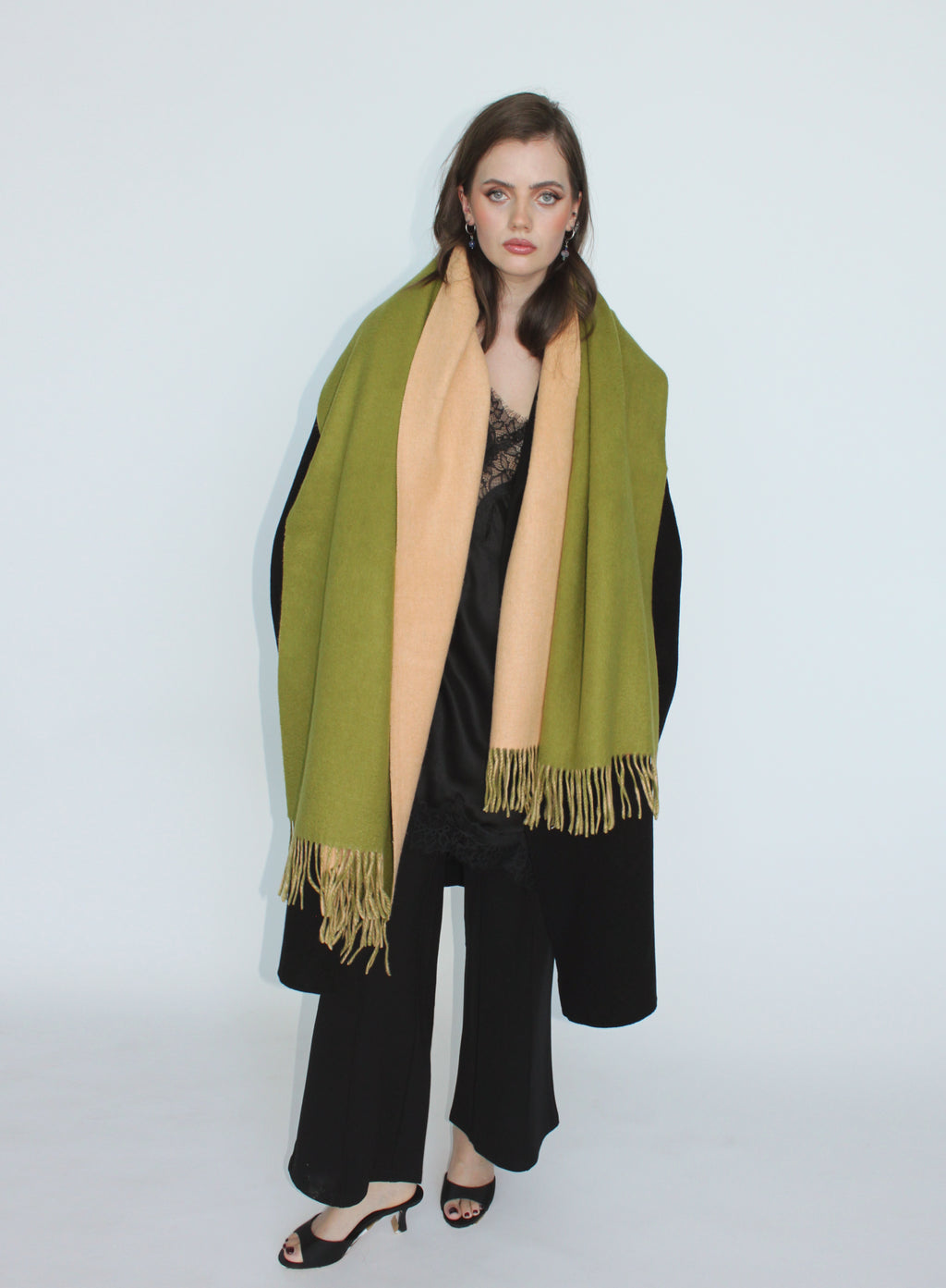 Woman wearing a green and beige scarf on a white background
