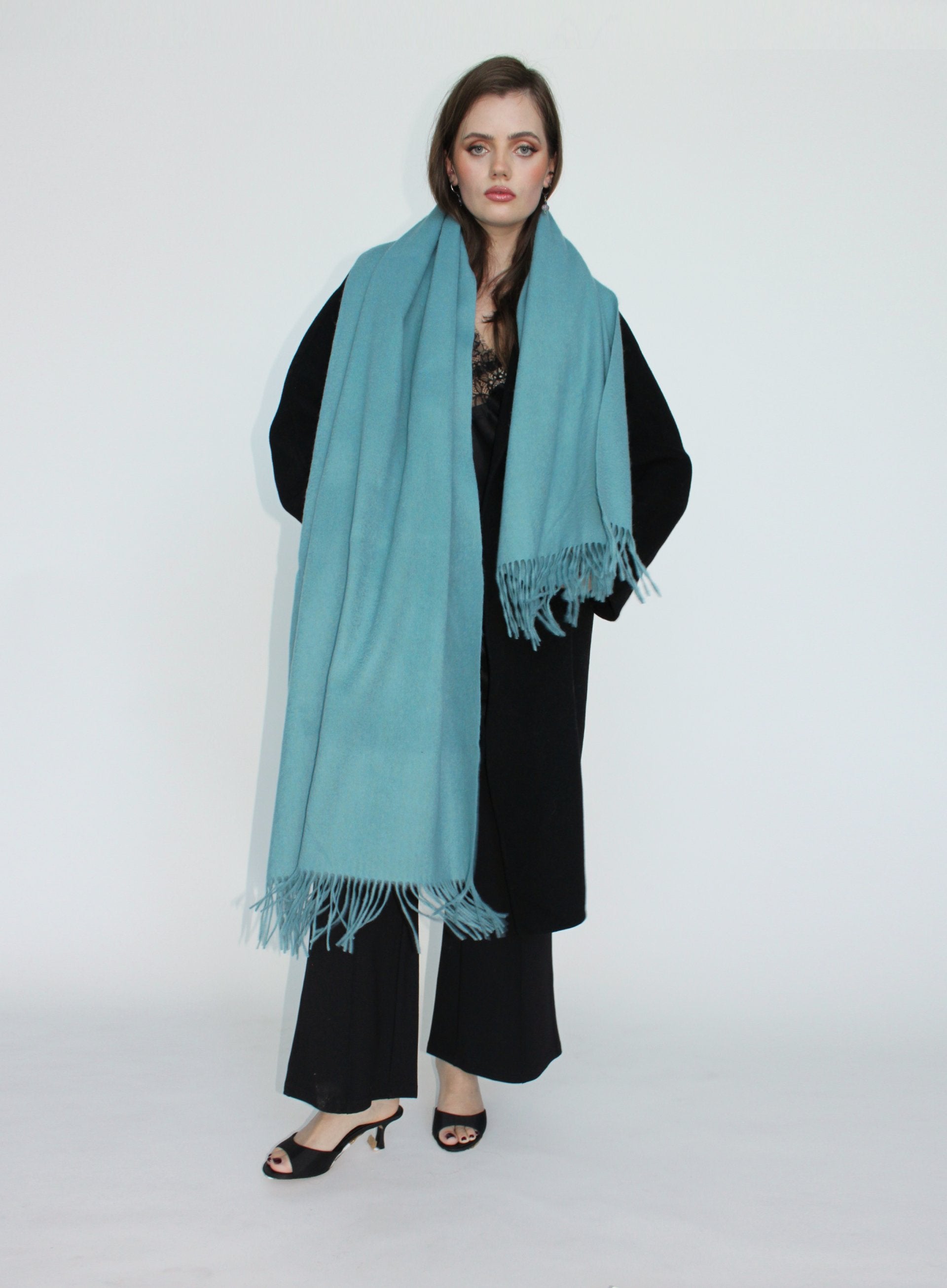 Woman wearing a light blue scarf on a white background