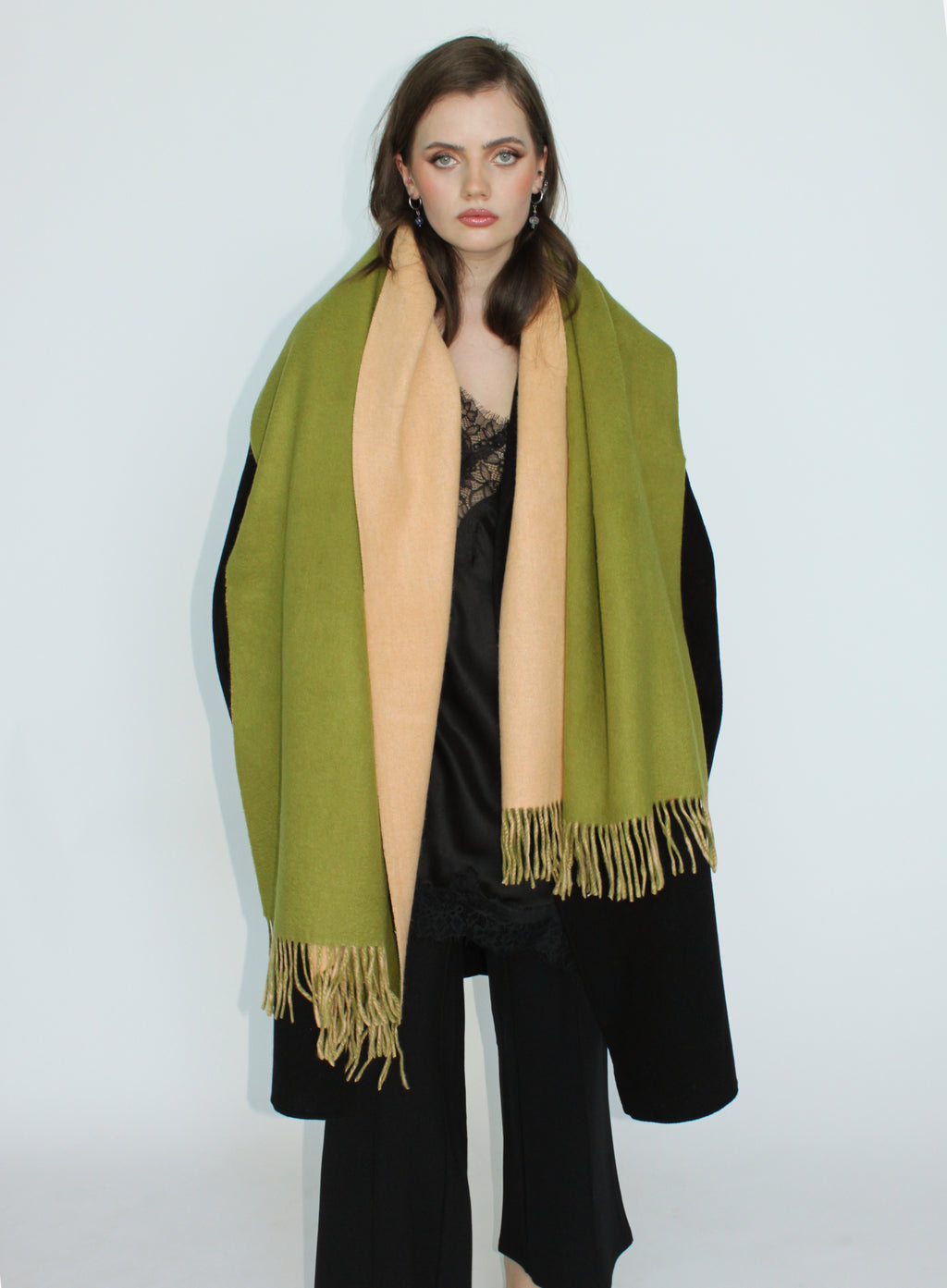 Woman wearing a green scarf with a white background