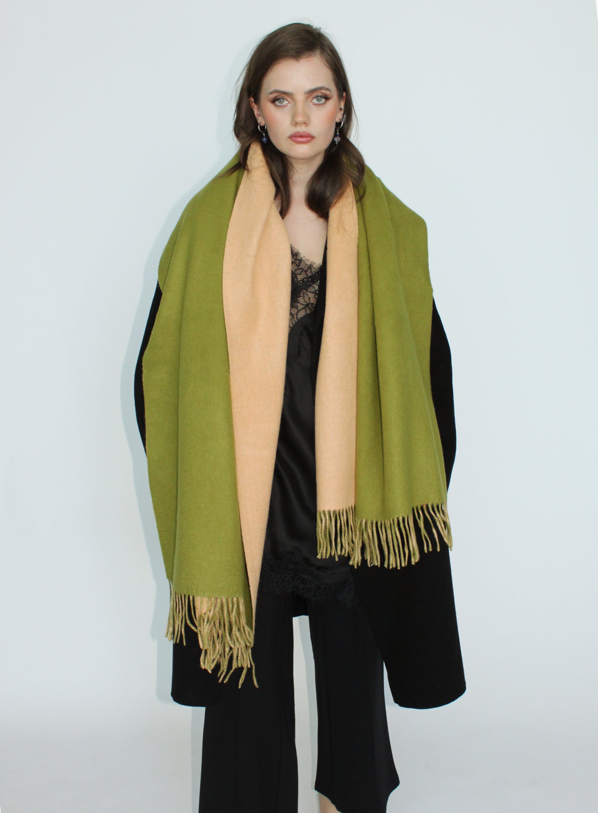Woman wearing a green scarf with a white background