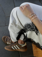 woman multiple silk cord pearls bracelets