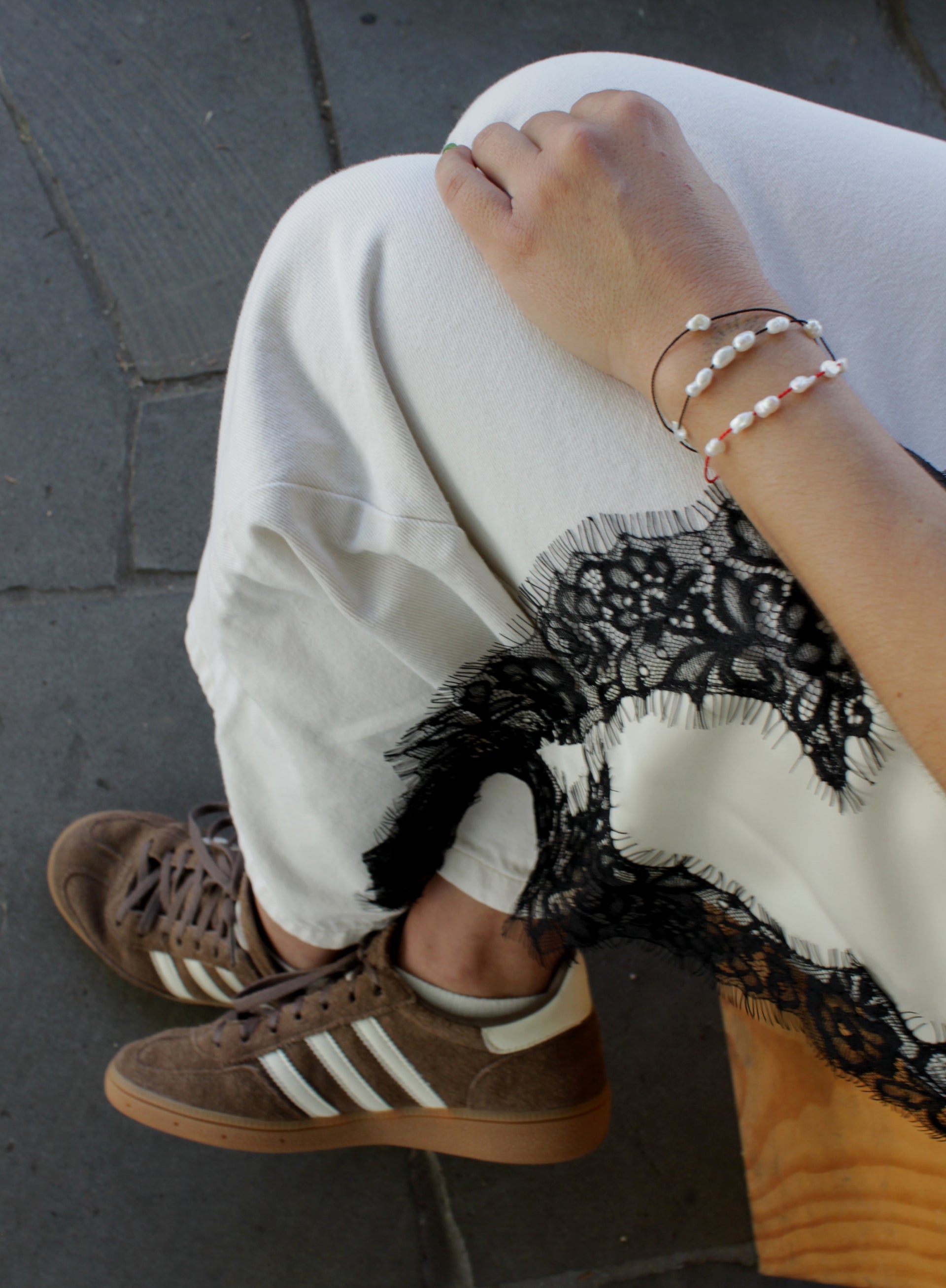 woman multiple silk cord pearls bracelets