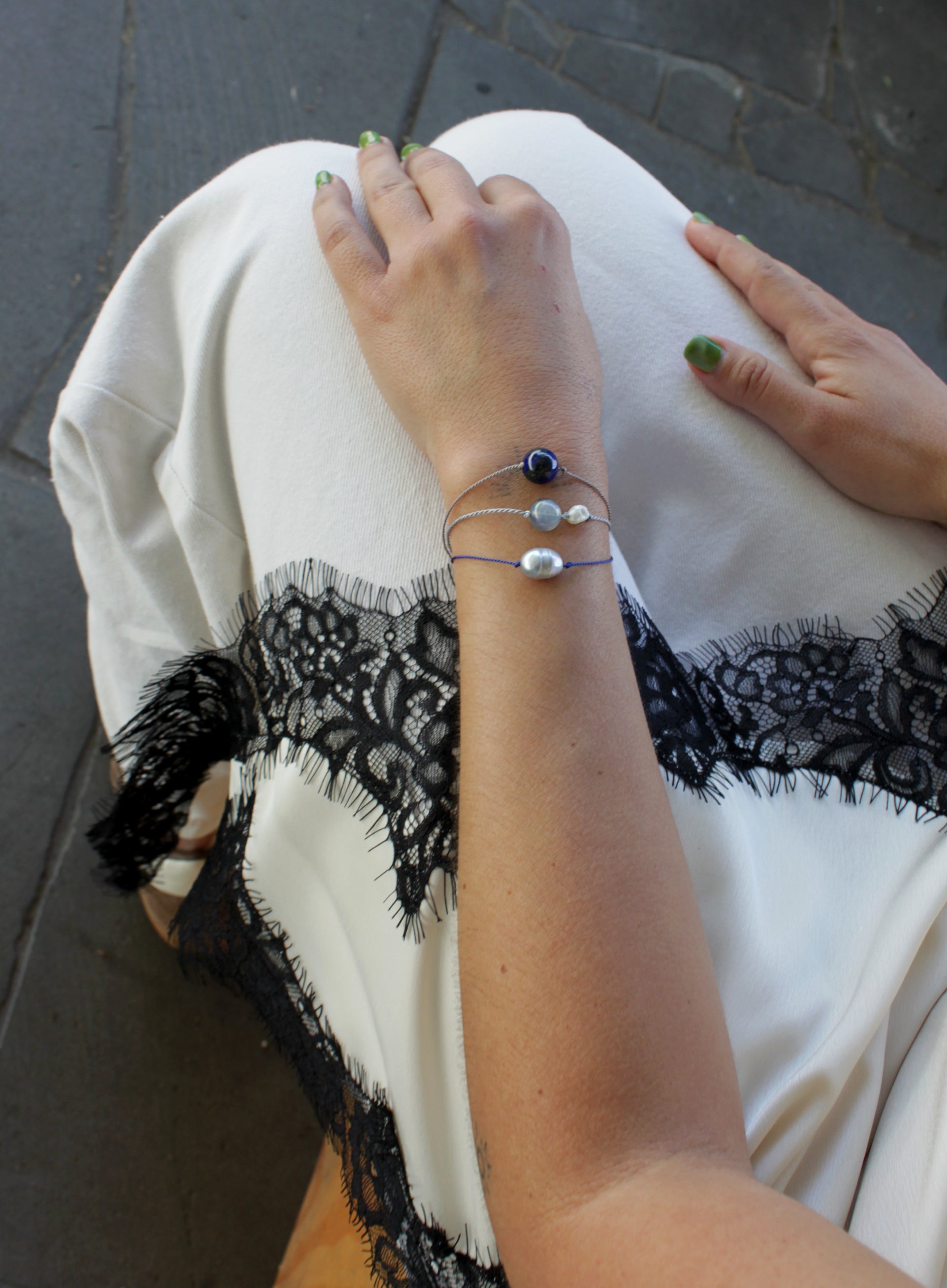 woman multiple silk cord beaded bracelets