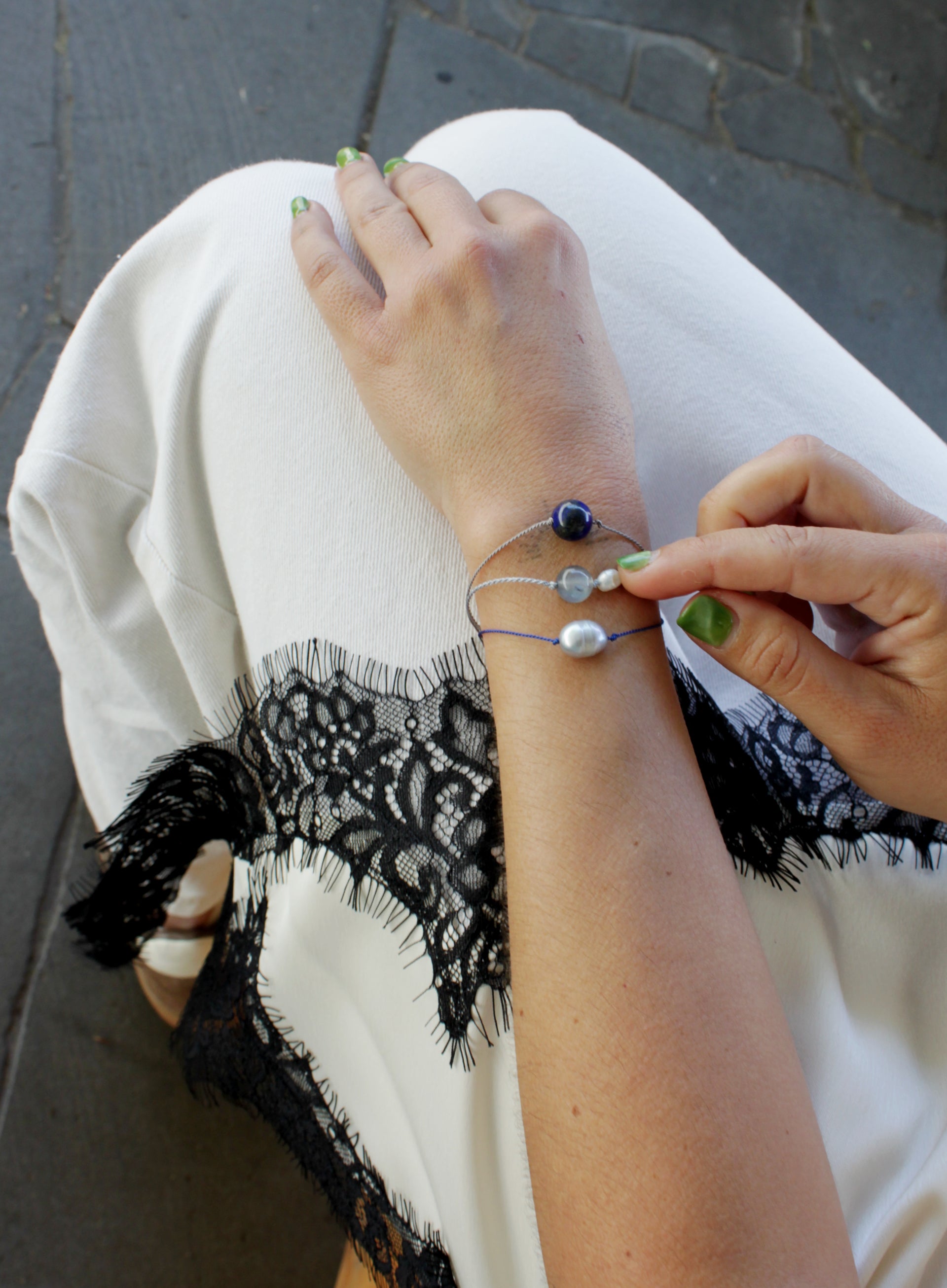 woman multiple silk cord beaded bracelets