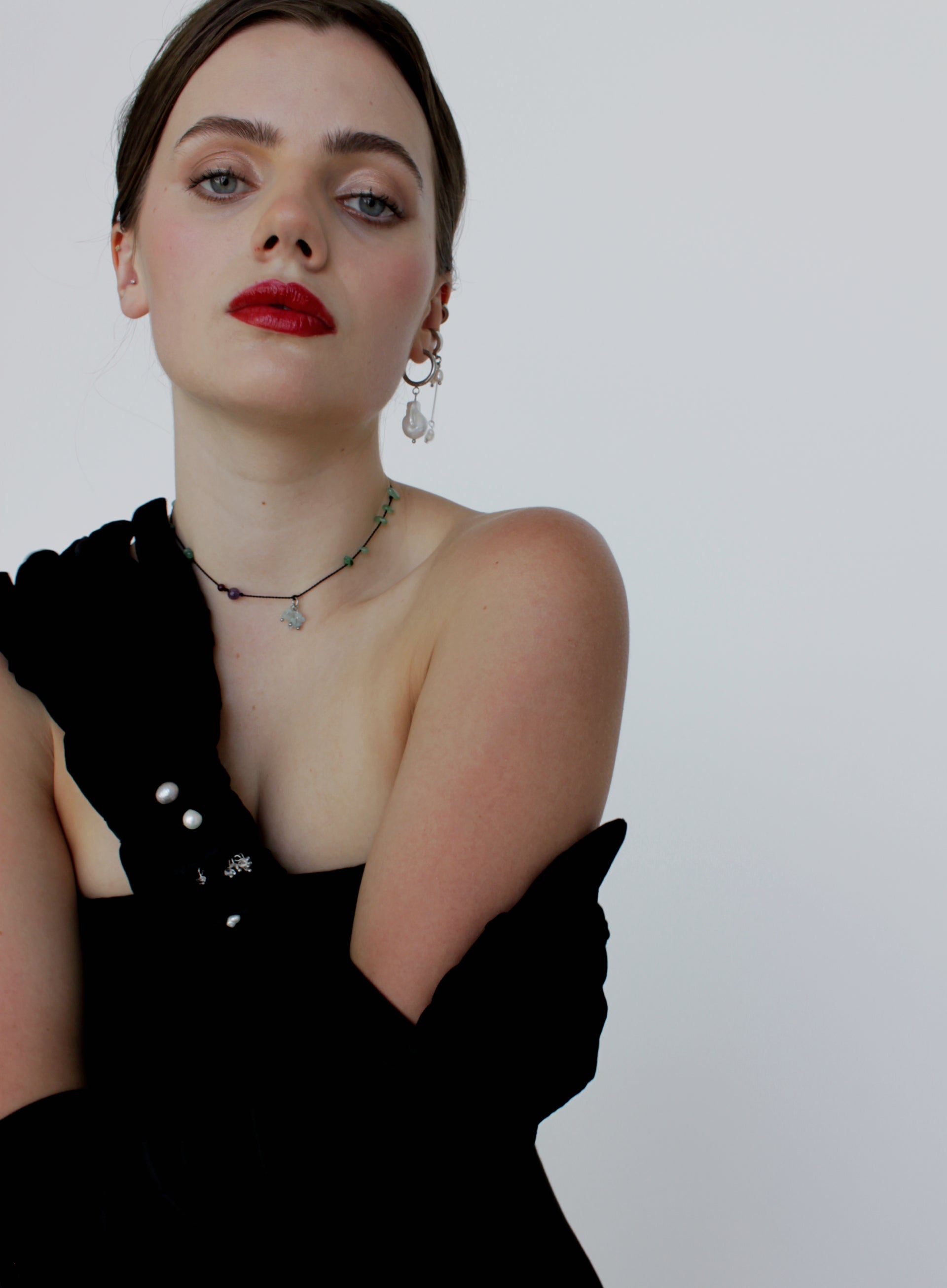 Woman wearing a black dress with a white background