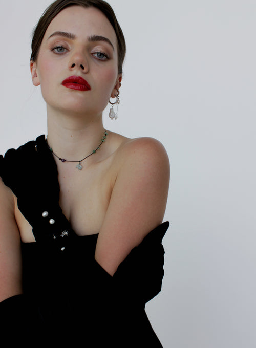 Woman wearing a black dress with a white background