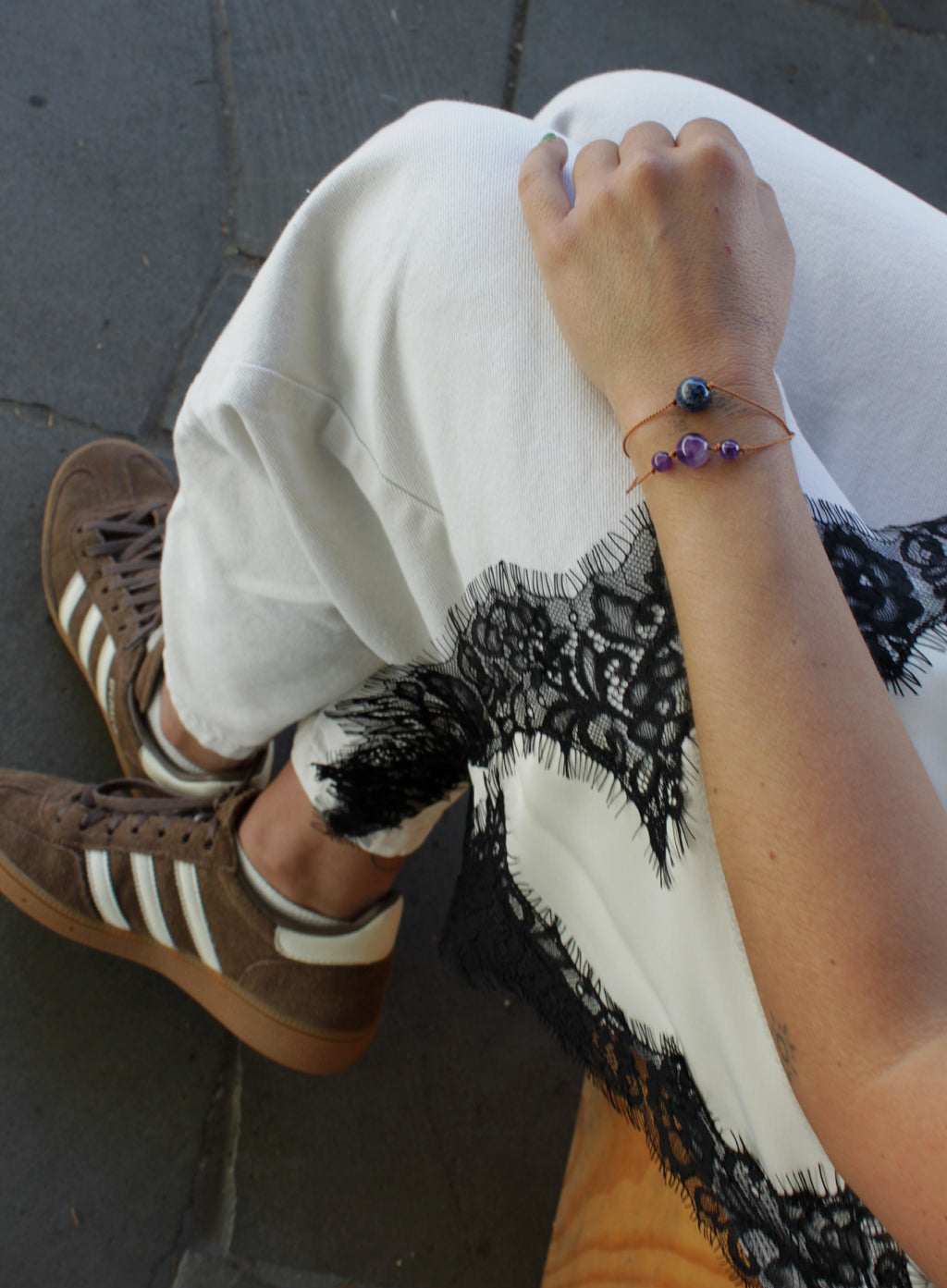 woman multiple silk cord beaded bracelets