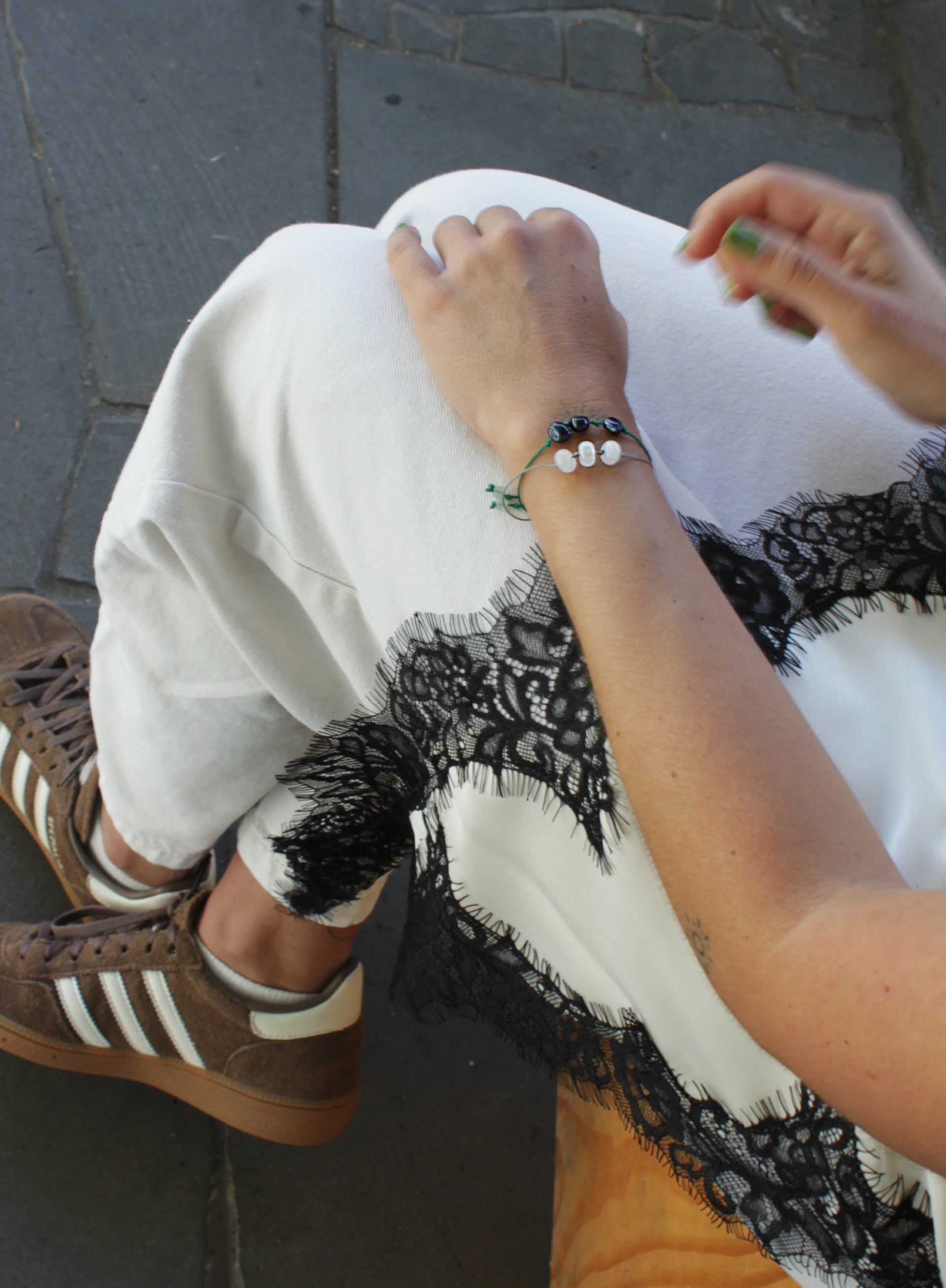 woman multiple silk cord beaded bracelets